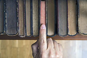 historical books with finger pointing
